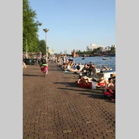 Tiny Houseboat On The Amstel River Amsterdam